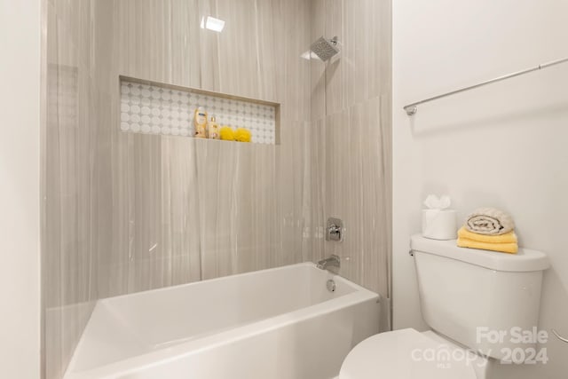 bathroom with tiled shower / bath and toilet