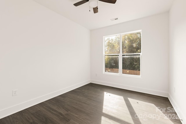 empty room featuring ceiling fan and dark hardwood / wood-style floors