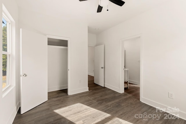 unfurnished bedroom featuring dark hardwood / wood-style flooring, a closet, and ceiling fan