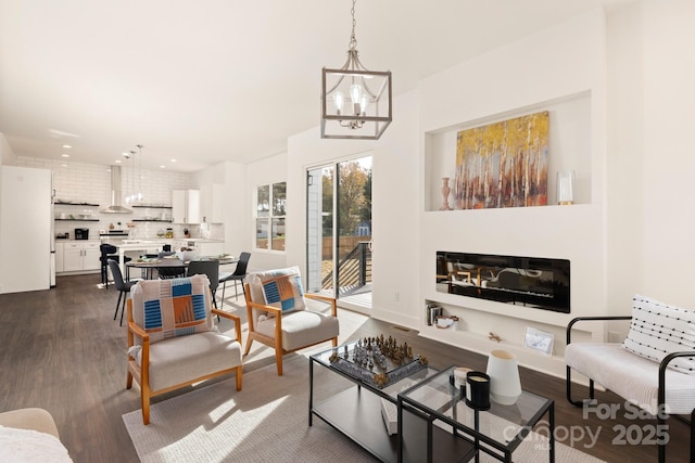 9000 Boyd Dr, Matthews, NC 28105 - living room featuring dark wood-style flooring, a chandelier, a glass covered fireplace, and recessed lighting