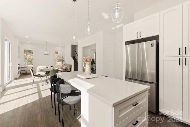 9000 Boyd Dr, Matthews, NC 28105 - kitchen featuring freestanding refrigerator, a center island, light countertops, dark wood-type flooring, and decorative light fixtures
