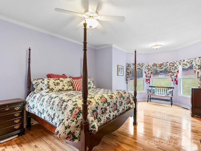 bedroom featuring ornamental molding, light hardwood / wood-style flooring, and ceiling fan