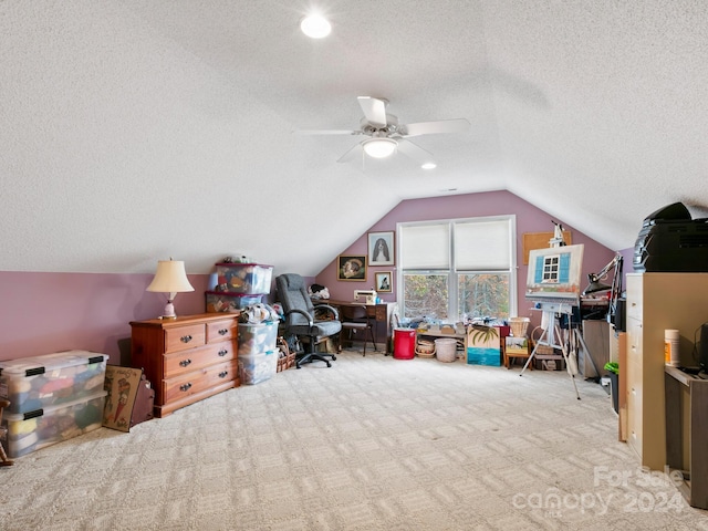 carpeted home office featuring ceiling fan, a textured ceiling, and lofted ceiling