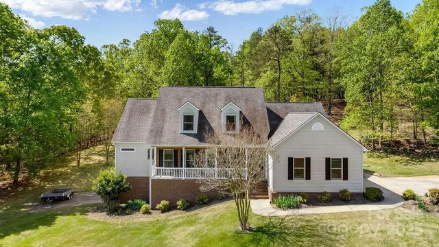 170 Stoneybrook Way, Tryon, NC 28782 - cape cod-style house featuring a porch, a front lawn, and brick siding