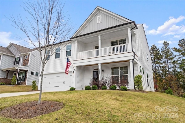 view of front of property with a garage, a front yard, and a balcony