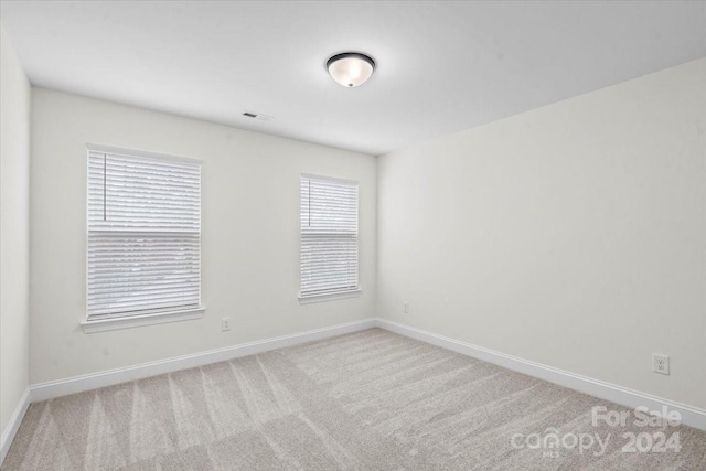 unfurnished room with light carpet