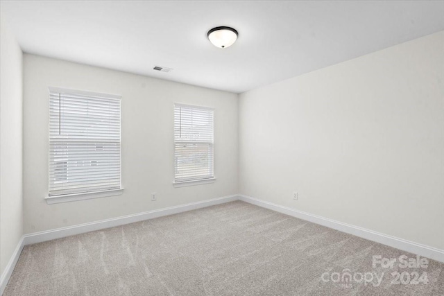 spare room with light carpet