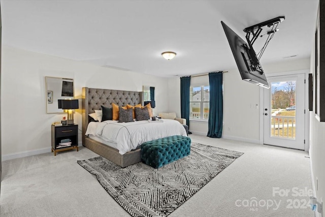 bedroom featuring light colored carpet and access to exterior