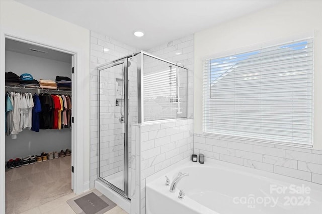 bathroom featuring shower with separate bathtub and tile patterned floors