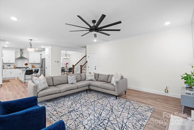 122 W Heart Pine Ln, Statesville, NC 28677 - living room featuring light wood-style flooring, recessed lighting, crown molding, ceiling fan, and a chandelier
