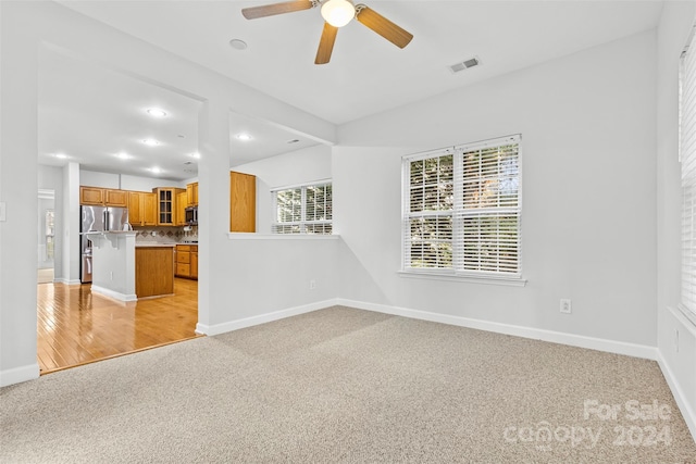 interior space with ceiling fan