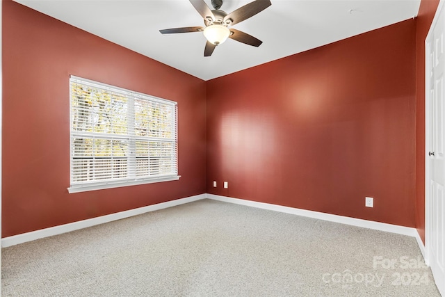 unfurnished room with ceiling fan and carpet floors