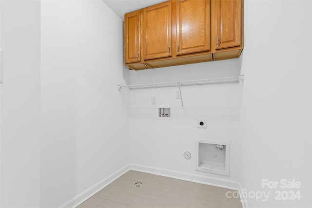 washroom with electric dryer hookup, hookup for a gas dryer, cabinets, and hookup for a washing machine