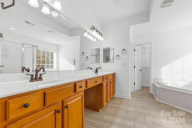 bathroom featuring plus walk in shower and vanity