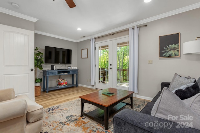 living room featuring french doors, hardwood / wood-style flooring, ceiling fan, and crown molding