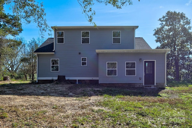 rear view of property with a lawn