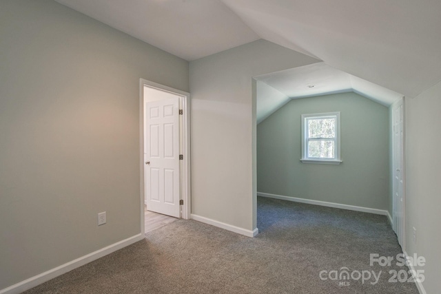 bonus room with baseboards, carpet, and lofted ceiling