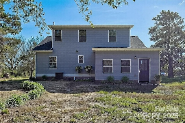 rear view of house featuring central AC