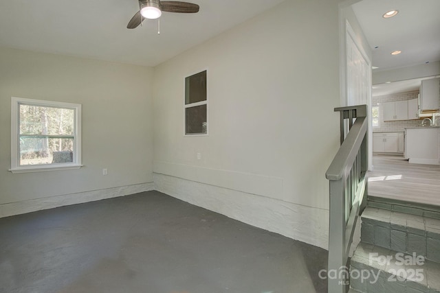 interior space with a wealth of natural light, recessed lighting, concrete floors, and ceiling fan