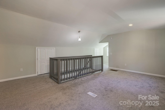 additional living space with visible vents, baseboards, and carpet