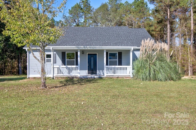 view of front of home featuring covered porch, a front yard, and roof with shingles