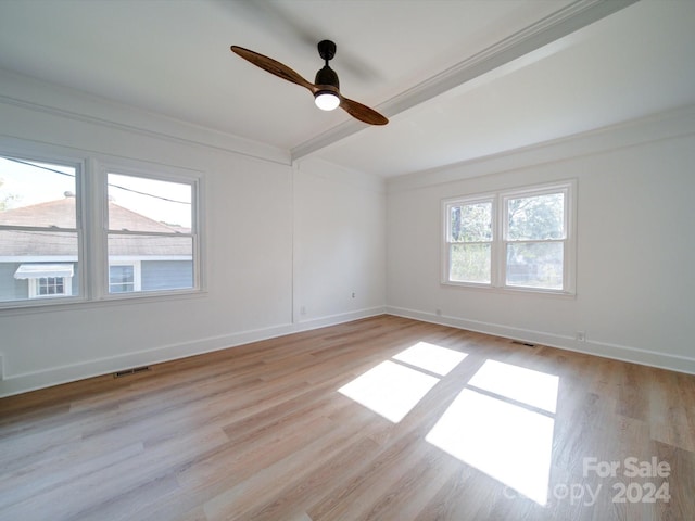 empty room with light hardwood / wood-style floors, ceiling fan, and a healthy amount of sunlight