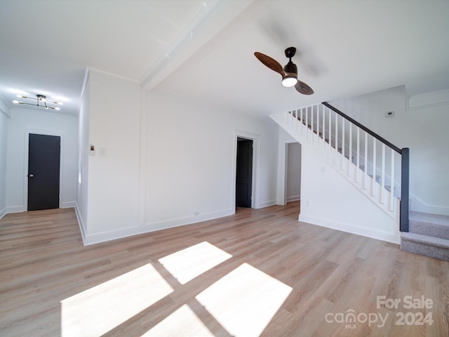 unfurnished living room with ceiling fan, light hardwood / wood-style floors, and beam ceiling