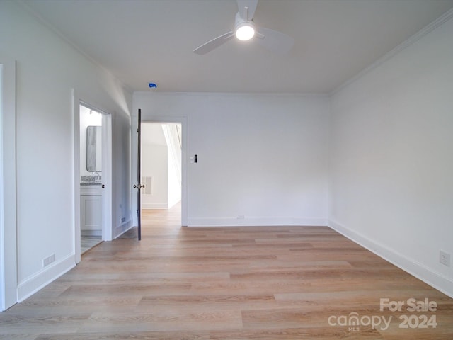 empty room featuring ornamental molding, light hardwood / wood-style floors, and ceiling fan