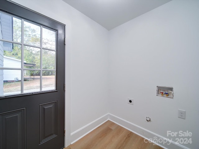 laundry area with light hardwood / wood-style floors, electric dryer hookup, and washer hookup