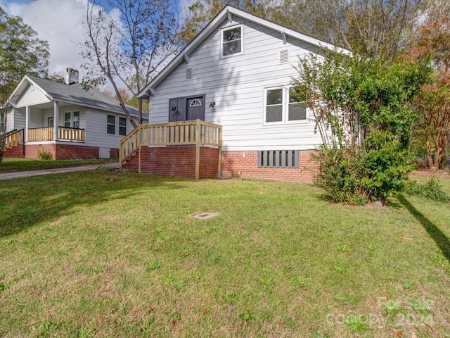 rear view of property with a lawn