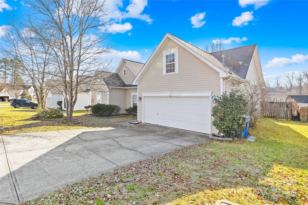 view of side of property with a garage and a yard