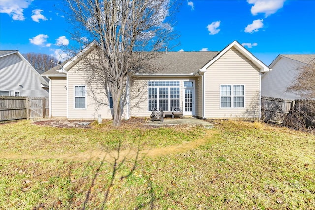 rear view of property featuring a patio area and a lawn