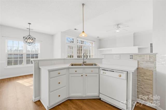 kitchen featuring sink, white cabinetry, dishwasher, pendant lighting, and light hardwood / wood-style floors