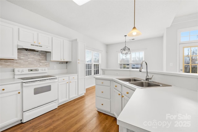 kitchen with white cabinetry, sink, hanging light fixtures, and white range with electric stovetop