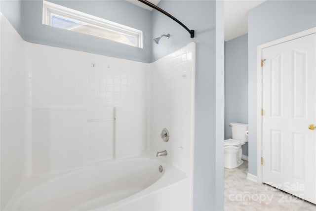 bathroom with shower / bathing tub combination, tile patterned flooring, and toilet