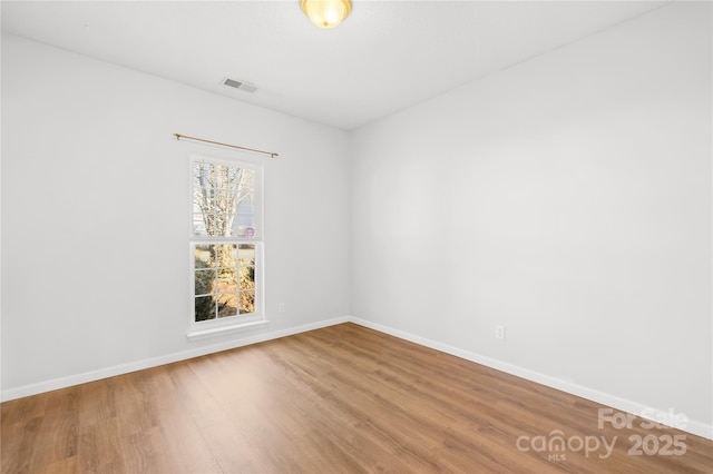 spare room featuring wood-type flooring