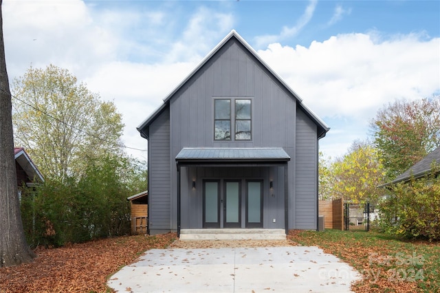 rear view of house featuring french doors