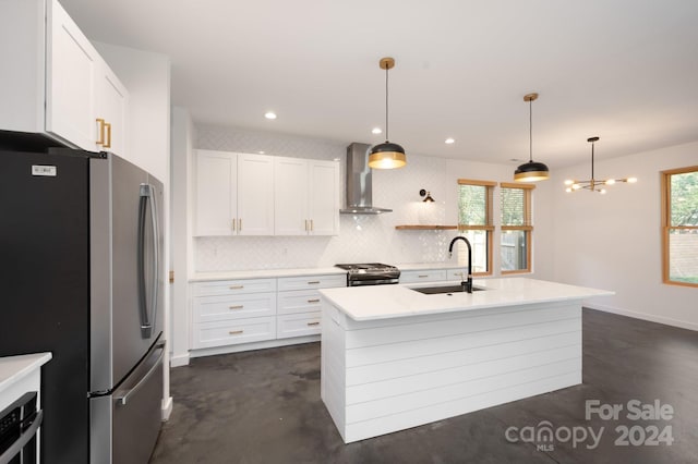 kitchen with sink, appliances with stainless steel finishes, tasteful backsplash, white cabinets, and wall chimney range hood