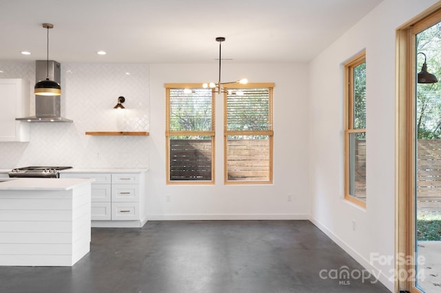 unfurnished dining area with a chandelier