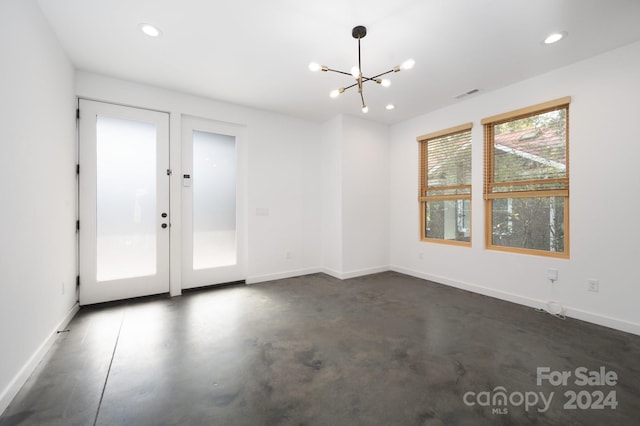 empty room with a notable chandelier