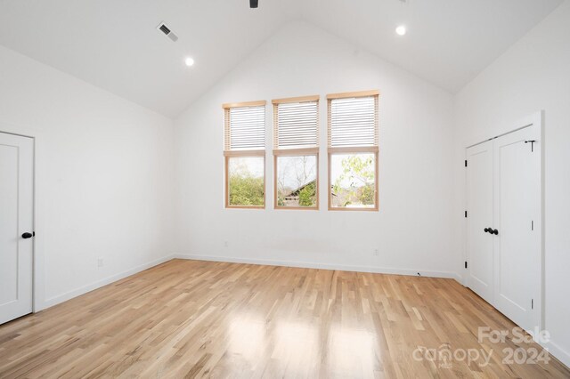 interior space with high vaulted ceiling and light hardwood / wood-style flooring