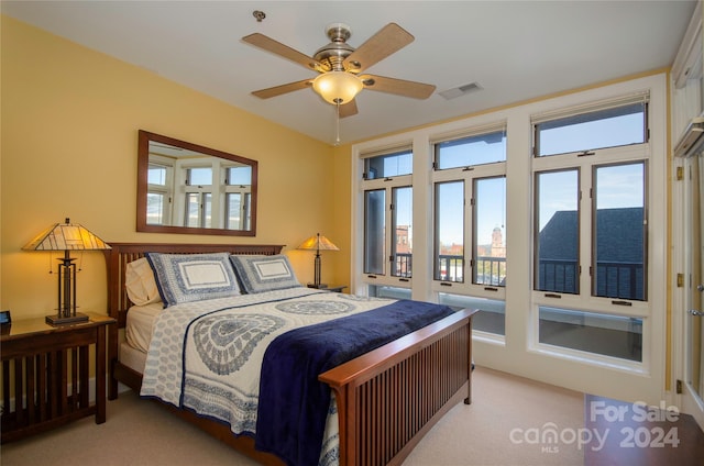 bedroom featuring light colored carpet and ceiling fan