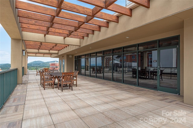 view of patio / terrace with a mountain view and a pergola