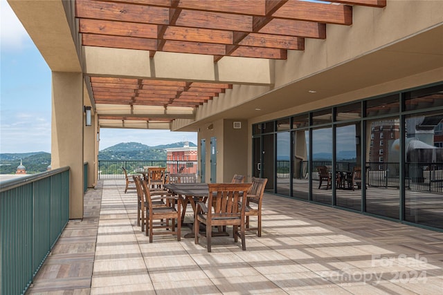 view of patio / terrace featuring a pergola and a mountain view