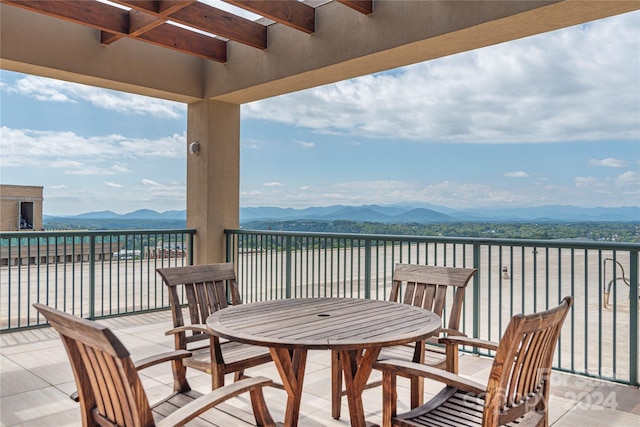 view of patio / terrace featuring a mountain view and a balcony