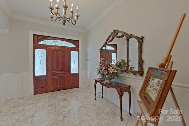 foyer with a notable chandelier and crown molding