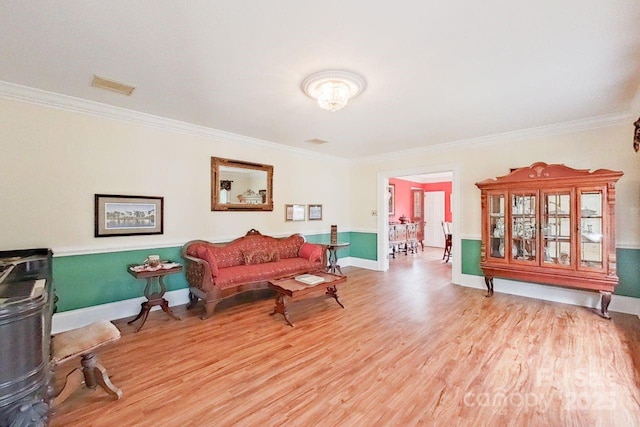 living room with light hardwood / wood-style flooring and ornamental molding