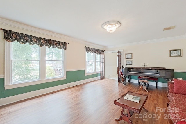 living room with crown molding and hardwood / wood-style flooring