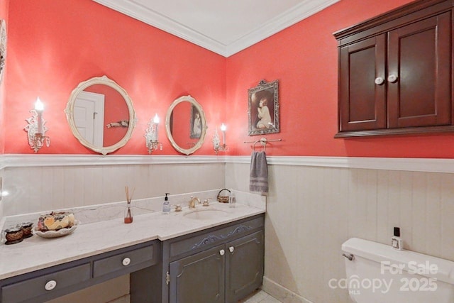 bathroom featuring toilet, vanity, ornamental molding, and wooden walls