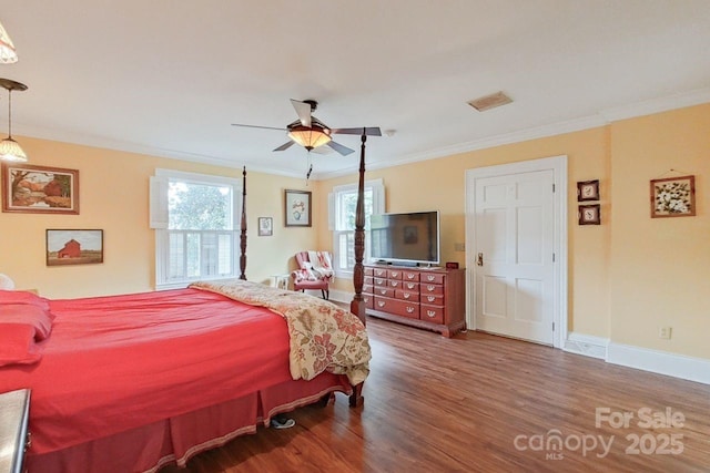 bedroom featuring ceiling fan, dark hardwood / wood-style flooring, and crown molding